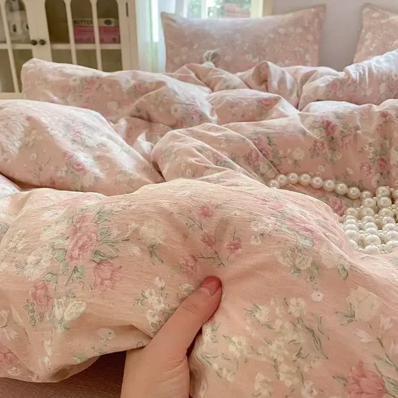 Soft pink floral jacquard fitted sheet set with delicate pastel blossoms and textured yarn for bedroom use