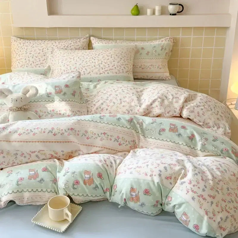 Pastel green and cream floral-patterned fitted sheet set with cartoon animal motifs in soft textured yarn