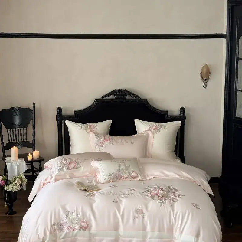 Blush pink satin embroidery bedding set with flowers embroidery bedding and matching pillows on black wooden headboard