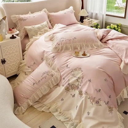 Pink satin-like bedding set with delicate flowers lace ruffles embroidery and cream trim made of egyptian cotton