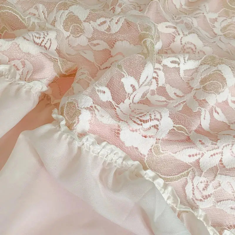 Delicate white floral lace overlay with soft pink satin lining and ruffled hem on pink french princess bedding set