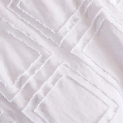 White textured fabric with a geometric quilted pattern of overlapping squares for decorbites geometric cut bedding set