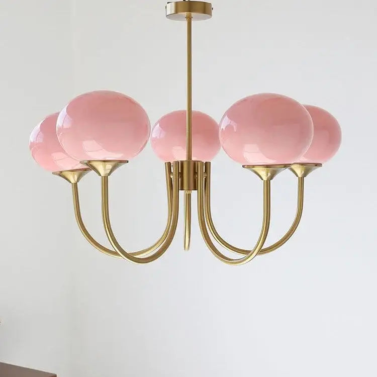 Delicate brass pendant lights with five translucent pink glass globe shades from decorbites designer loft pendant collection