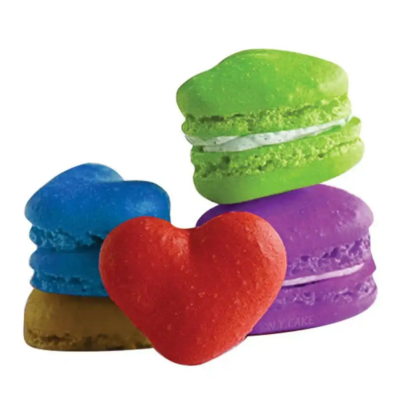 A vibrant red heart-shaped macaron on a pink heart silicone macaron baking mat by decorbites silicone for macaron baking