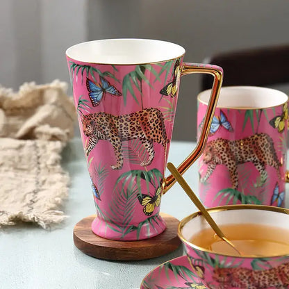 Pink jungle animals bone china teacup with gold rim and handle featuring vibrant leopards butterflies and leaves decorbites jungle animals