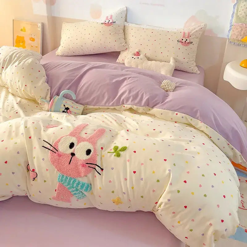 Cream-colored quilted decorbites cotton bedding set with plush pink bunny and multicolored heart patterns for bedroom