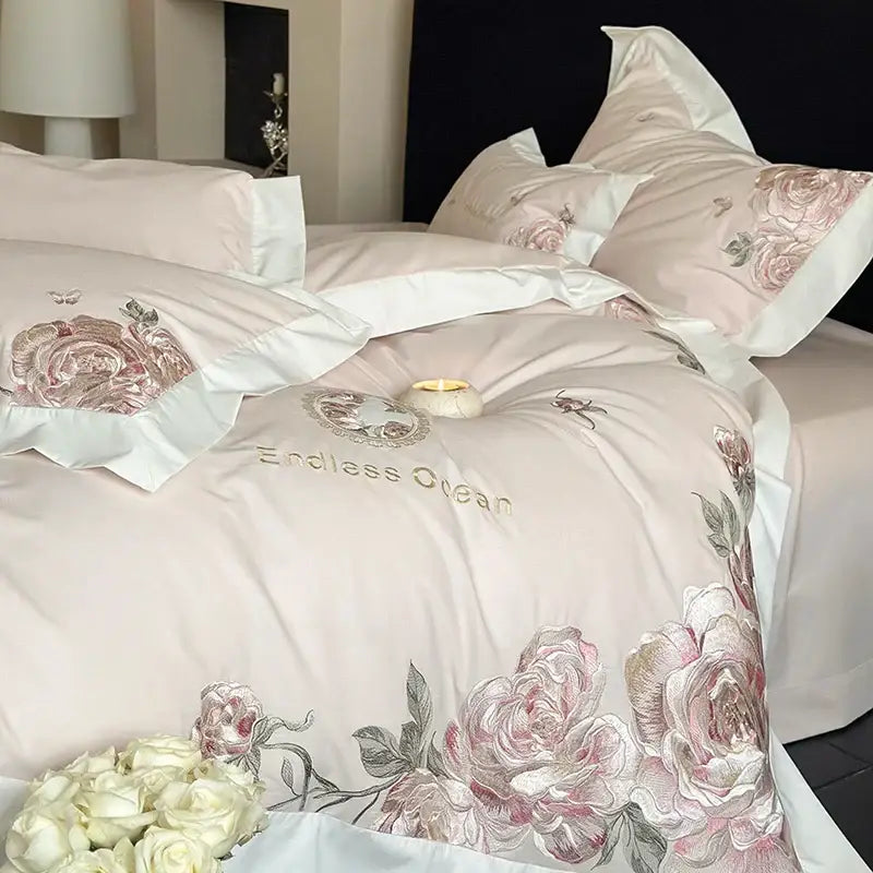Pink satin bedding set with intricate pink purple flowers embroidery and white piping made from egyptian cotton