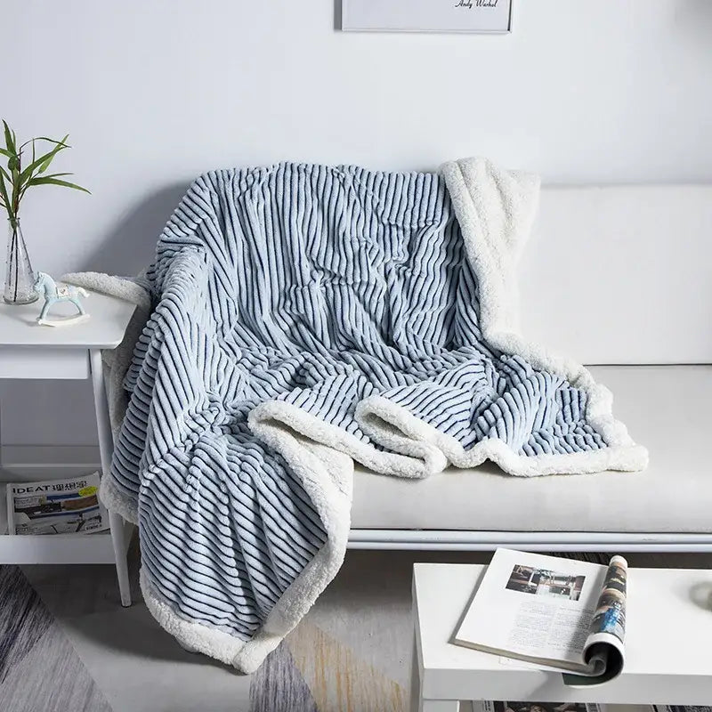Cozy nordic wool throw blanket decorbites with light blue and white striped fleece and plush sherpa-lined edge