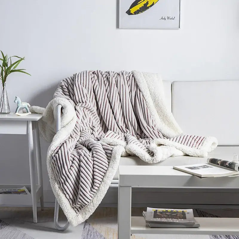 A plush taupe throw blanket with ribbed texture and soft white sherpa lining from decorbites cozy nordic wool collection
