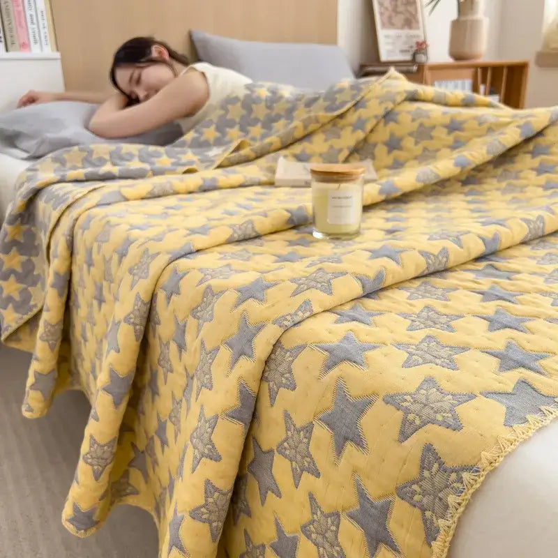 Yellow cotton towel blanket with gray star patterns and frayed edges from decorbites cotton towel collection