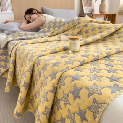 Yellow cotton towel blanket with gray star patterns and frayed edges from decorbites cotton towel collection