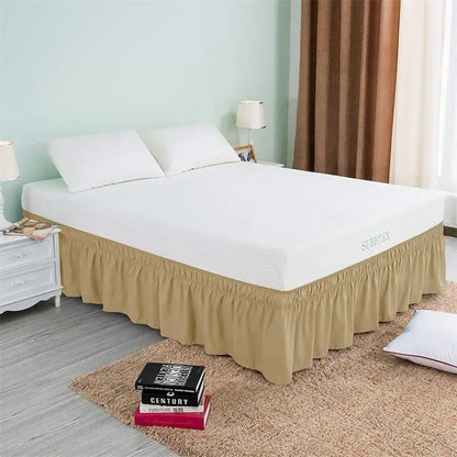 Beige ruffled elastic bed skirt with elasticized hem and surrey branding on mattress cover for bedroom use