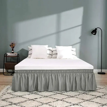 Gray ruffled elastic bed skirt with gathered elastic band at the top for a soft solid color bedroom wrap around