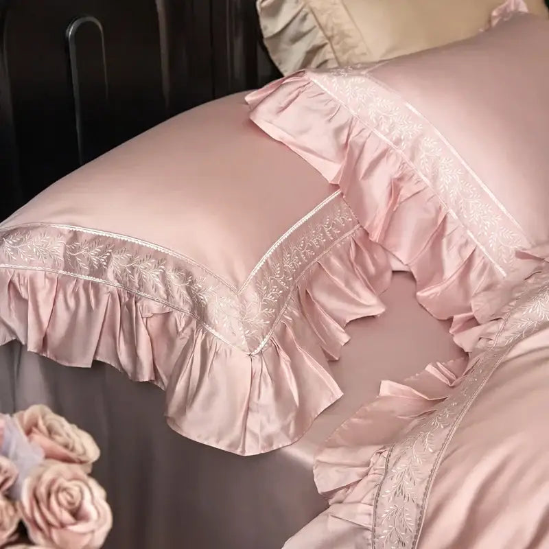 A delicate blush pink satin pillow sham with soft ruffles and silver embroidery from decorbites 1000tc luxury bedding set