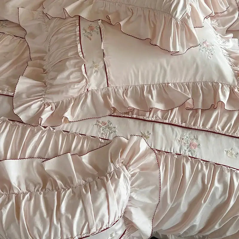 Pastel pink satin pillowcases with delicate floral embroidery and lace ruffles from decorbites 1000tc cotton bedding set