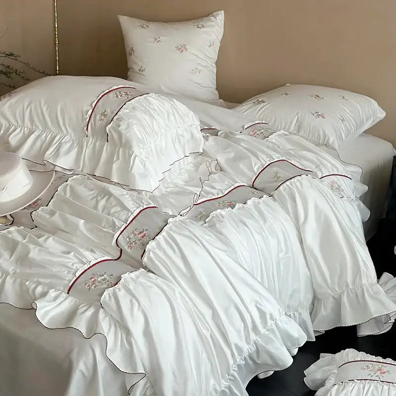 White satin bedding set with delicate floral embroidery and red-trimmed lace ruffles from decorbites 1000tc cotton