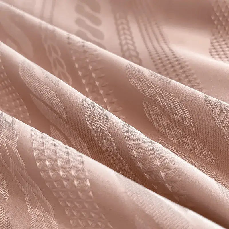 Soft blush pink satin jacquard duvet cover set with intricate woven geometric and leaf motifs and white piping
