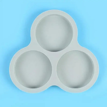 Gray silicone egg mold pancake tray with three rounded shallow compartments for mold pancake shaper use
