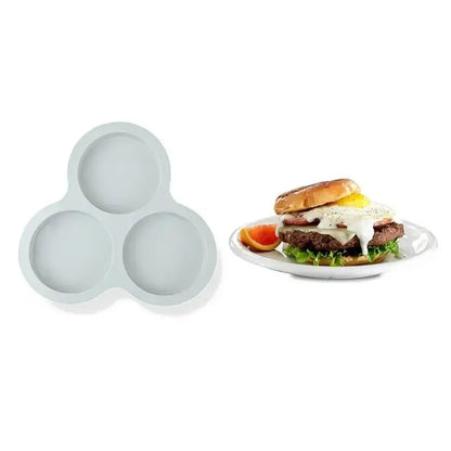 Light gray silicone three-egg mold pancake shaper for cooking muffins and eggs in the kitchen