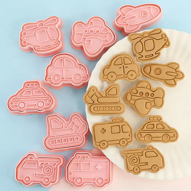 Set of pink silicone truck cookie cutters and aircraft shapes in a vehicle and aircraft cookie cutters set
