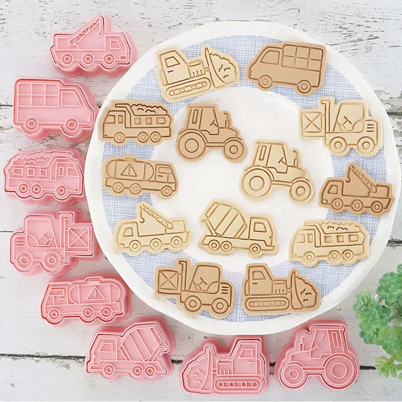 Set of pink and beige silicone truck cookie cutters featuring engineering trucks in a vehicle cookie cutters set