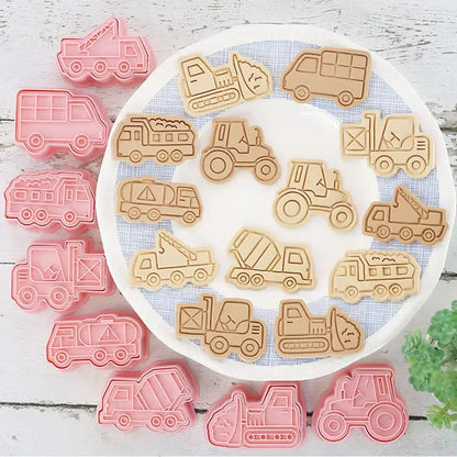 Set of pink and beige silicone truck cookie cutters featuring engineering trucks in a vehicle cookie cutters set