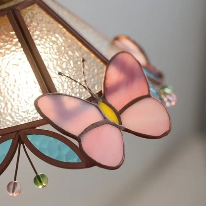 Pink and teal copper butterfly glass wall light with delicate stained glass and dangling colorful beads decorbites copper butterfly