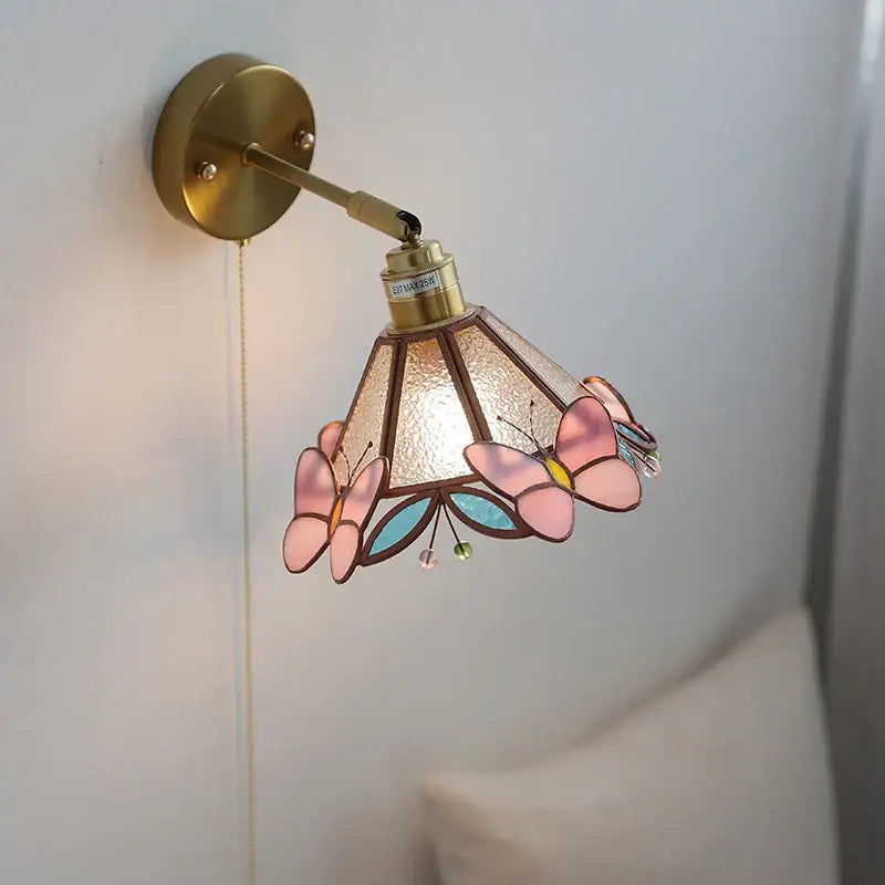 Pink and teal copper butterfly glass wall light with brass mounting bracket featuring delicate stained glass decorbites copper butterfly design