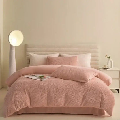 Pink textured winter fleece bedding set with matching pillows and tufted headboard in bedroom decor