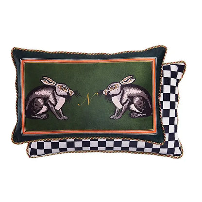 Deep green velvet cushion cover with embroidered rabbits, gold monogram, orange border, and braided trim for living room