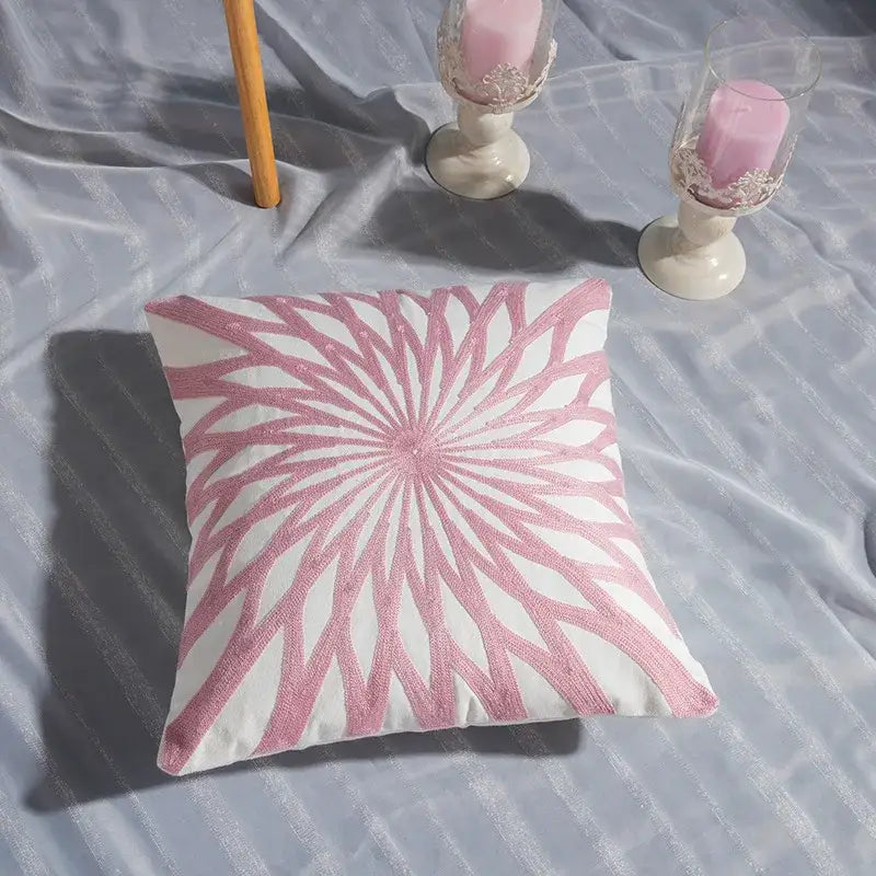 A square decorbites cotton flower embroidered pillow with white base and pink flower embroidered geometry pattern