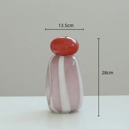 Translucent pink and white striped glass vase cover band with a glossy red rounded stopper for living room decor