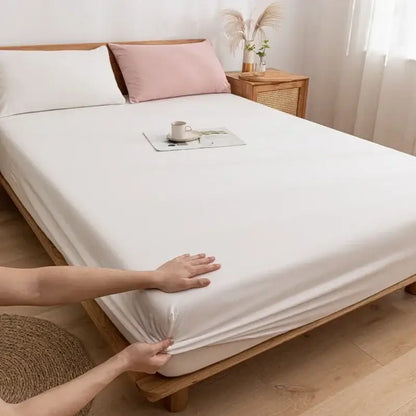 A smooth white decorbites cotton fitted sheet with elastic edge and snug fit for bedroom use