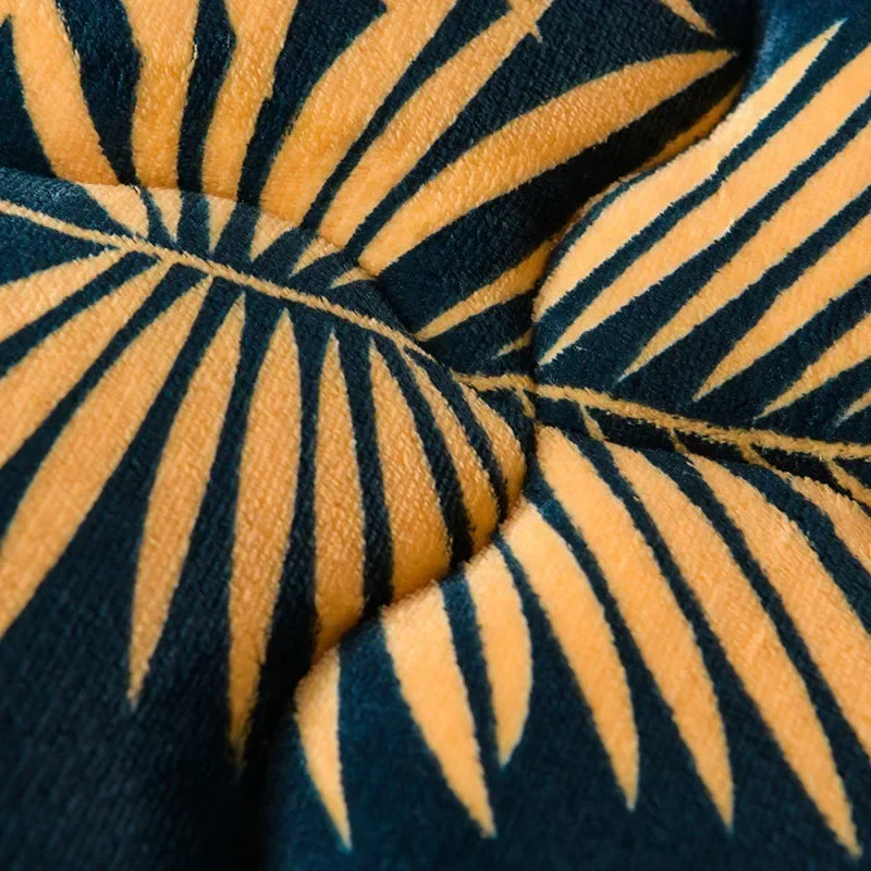 A plush navy blue and mustard yellow palm leaf patterned plaid super thick warm milk fleece blanket for winter and autumn