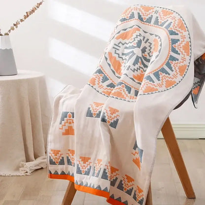 A soft off-white cotton lions bath towel with bold orange and gray geometric mandala pattern from decorbites