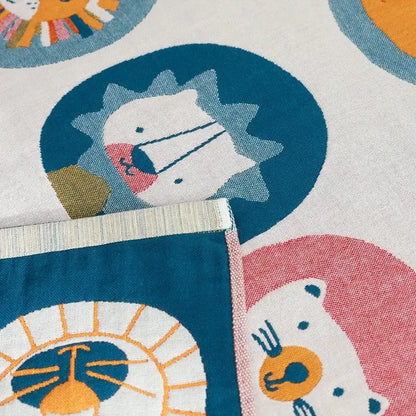 A soft white quick dry cotton bath towel with playful colorful lions and bears pattern for decorbites lions bath use