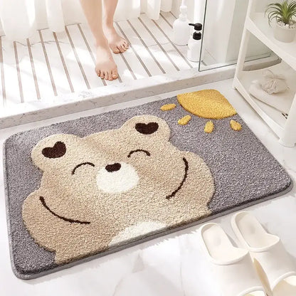 Gray plush bath rug featuring a smiling beige bear with heart eyes and yellow sun decorbites cartoon animal design