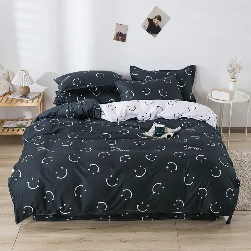 Black duvet cover set with white smiley face and star patterns complementing playful white and light blue dog print bedding set