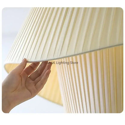 Cream white double pendant lamp with a cream-colored pleated lampshade and soft textured fabric for living room decorbites