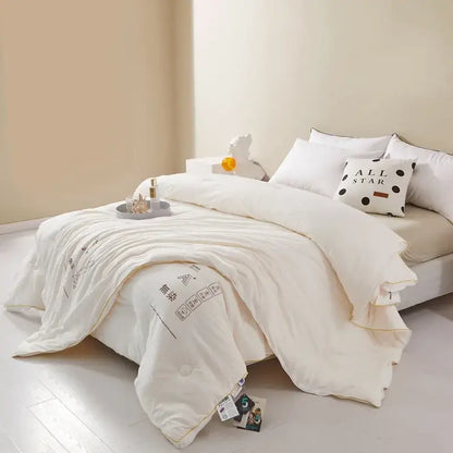 Plush cream cozy soy fiber quilt with subtle black text and soft texture ideal for bedroom bedding decorbites cozy soy