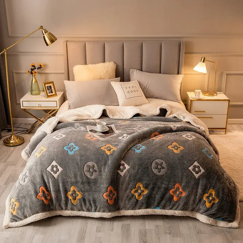 Gray fleece wool blanket with colorful floral and geometric patterns and a soft sherpa-lined edge for bedroom use