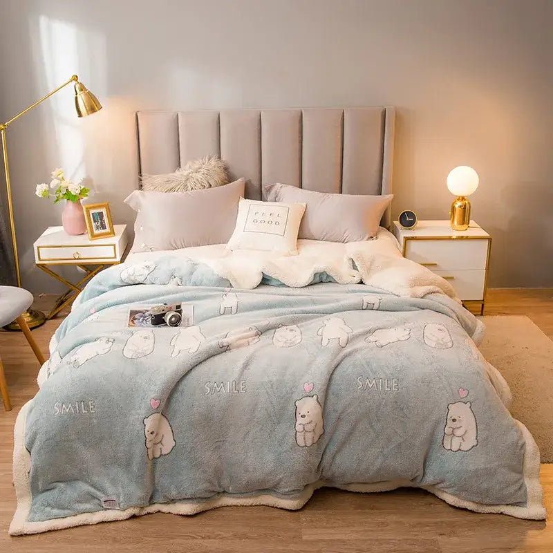 Light blue fleece wool blanket with white polar bear smile print and sherpa lining for plush cream floral bedroom use