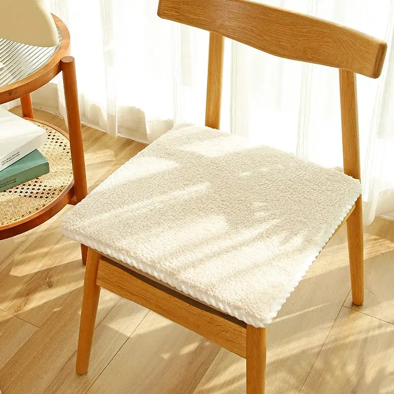 Cream-colored plush lambs wool chair cushion with soft texture and finished edges for dining room comfort decorbites cozy