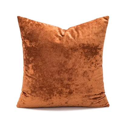A square rust-colored velvet pillow cover with dark grain texture ideal for living room decor