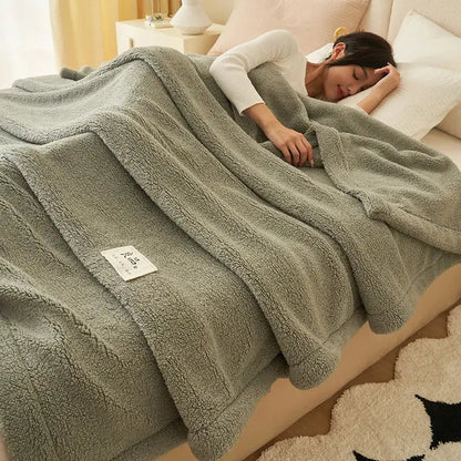 A soft olive green plush blanket with textured surface and white label made from decorbites coral fleece material