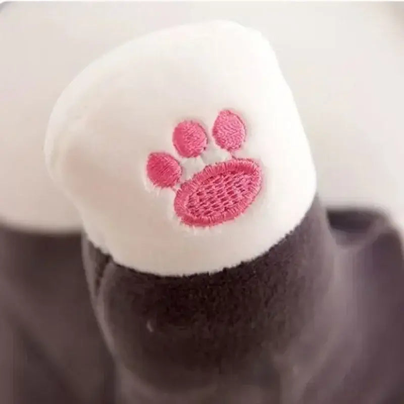 White plush hat with pink embroidered paw print paired with plush gray and white cat sleeping body pillow decorbites husky