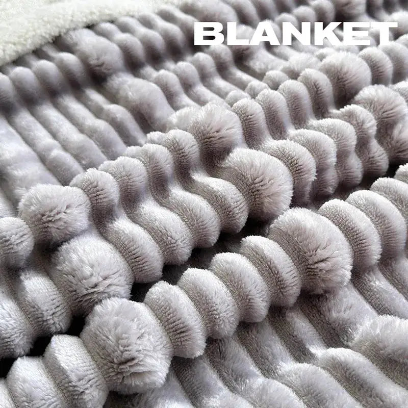 A soft light gray plush blanket with raised corduroy ridges made from cozy lamb wool by decorbites cozy lamb