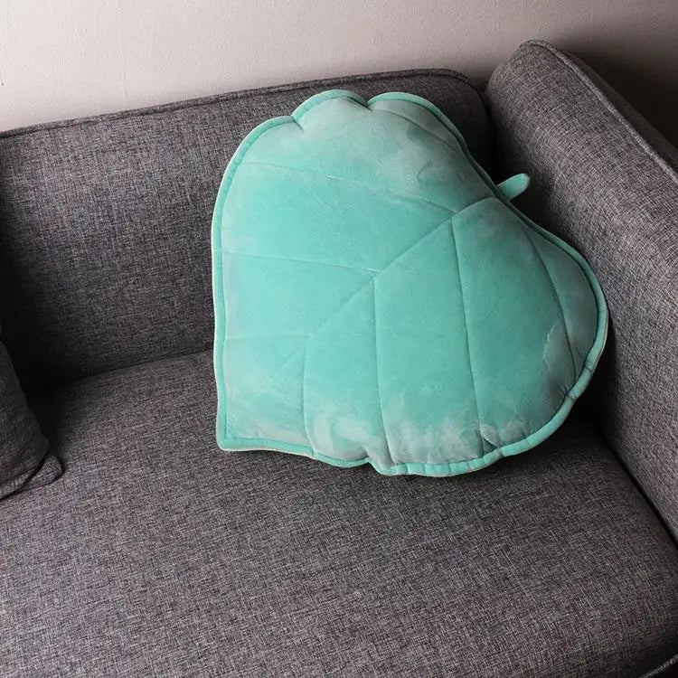 A soft mint green plush velvet throw pillow with a quilted decorbites 3d leaf design for living room decor