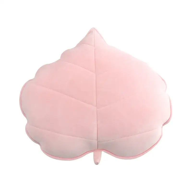 A soft pink leaf shaped throw pillow with stitched veins and stem from decorbites 3d leaf plush throw pillows collection