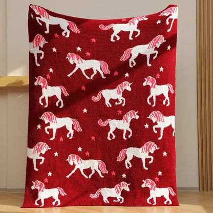 Plush red unicorn blanket featuring fleece red material with white unicorns and star patterns for bedroom use